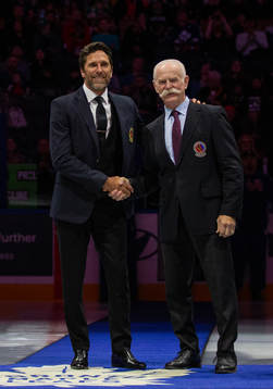 Henrik Lundqvist receives his blazer from Lanny McDonald