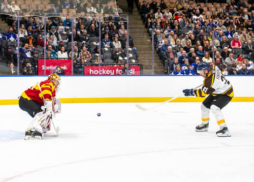 Henrik Lundqvist makes a save against Peter Forsberg