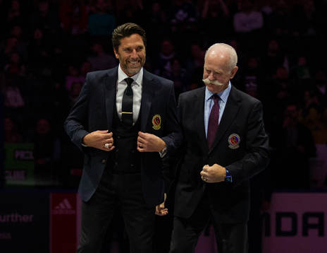 Henrik Lundqvist receives his blazer from Lanny McDonald