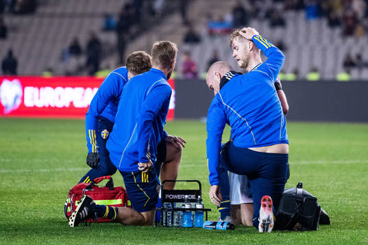 Filip Helander of Sweden receives medical attention