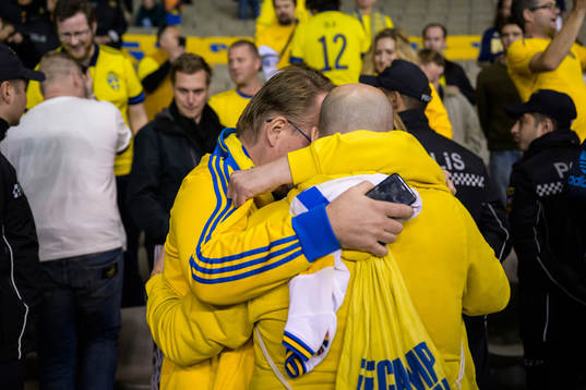 Swedish supporters Claes Durgé and David Forsberg hug