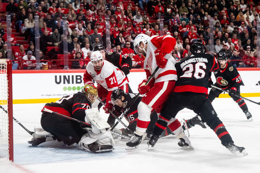 Dylan Larkin of Detroit Red Wings and goaltender Joonas