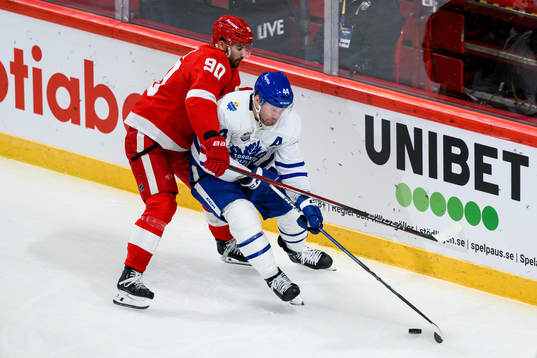 Joe Veleno of Detroit Red Wings and Morgan Rielly of