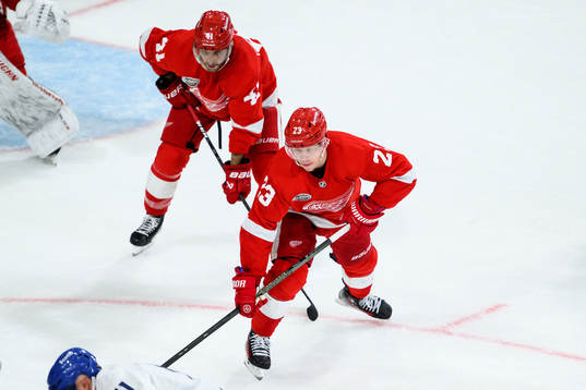Shayne Gostisbehere and Lucas Raymond of Detroit Red Wings