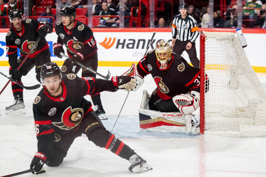 Erik Brännström and goaltender Anton Forsberg of Ottawa