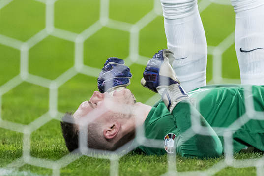 Goalkeeper Karl Jakob Hein of Estonia in pain