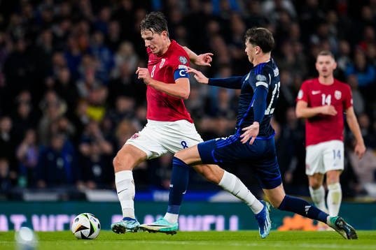 Sander Berge of Norway and Jack Hendry of Scotland