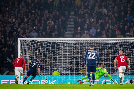 John McGinn of Scotland scores the 1-1 goal from the