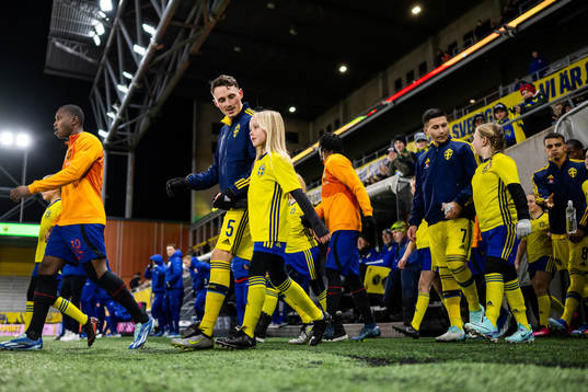 Noah Persson and Roony Bardghji of Sweden enter the pitch