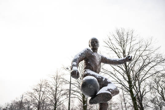 A statue covered in snow outside Gamla Ullevi