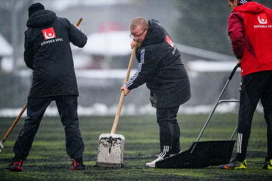 Staff swipes the pitch