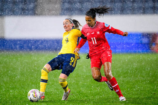 Kosovare Asllani of Sweden and Coumba Sow of Switzerland