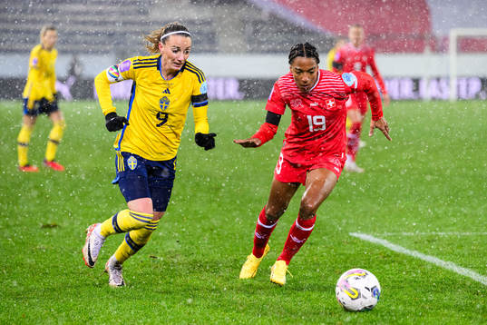 Kosovare Asllani of Sweden and Eseosa Aigbogun of