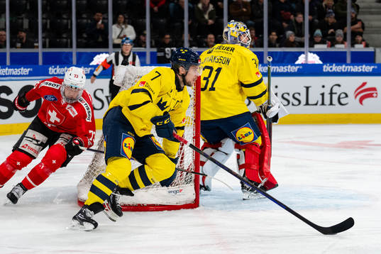Henrik Tömmernes and goaltender Lars Johansson of Sweden