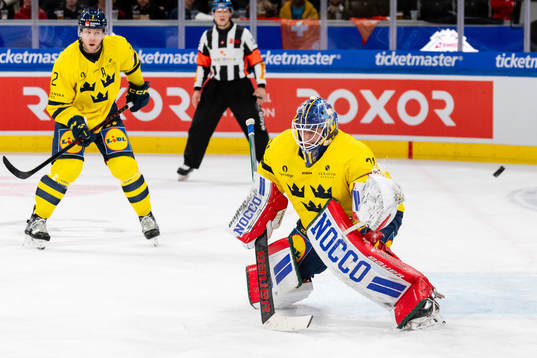 Christian Folin and goaltender Lars Johansson of Sweden in
