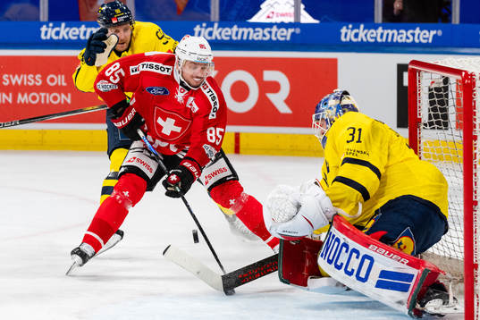 Sven Andrighetto of Switzerland and goaltender Lars