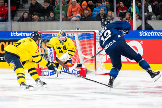 Goaltender Lars Johansson of Sweden and Jere Innala of