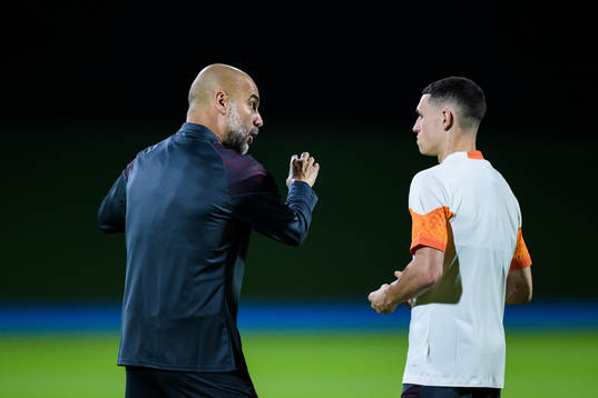 Head coach Pep Guardiola and Phil Foden of Manchester City