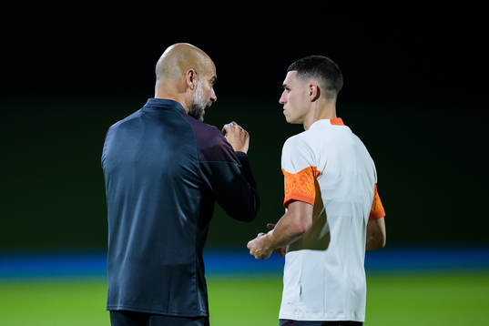 Head coach Pep Guardiola and Phil Foden of Manchester City