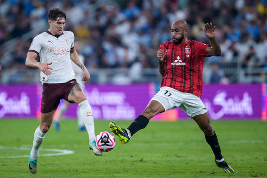 John Stones of Manchester City and Jose Kante of Urawa Reds