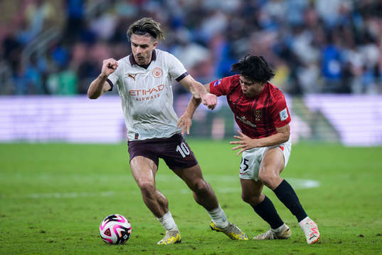Jack Grealish of Manchester City and Kaito Yasui of Urawa