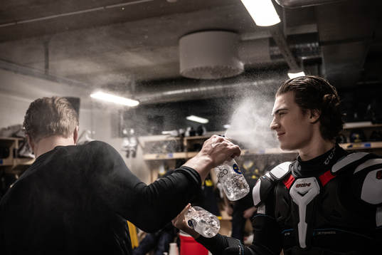 Elias Pettersson and Liam Öhgren sprays water at each other