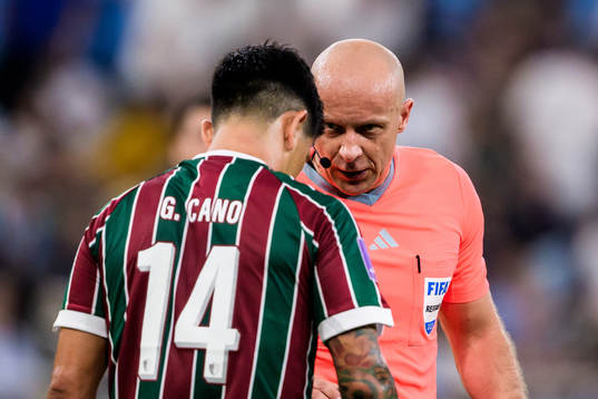 German Cano of Fluminense and referee Szymon Marciniak