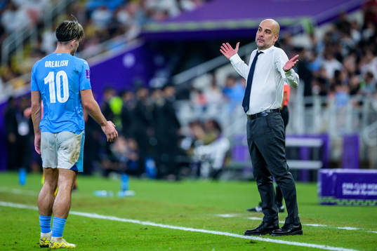 Jack Grealish and Head coach Pep Guardiola of Manchester
