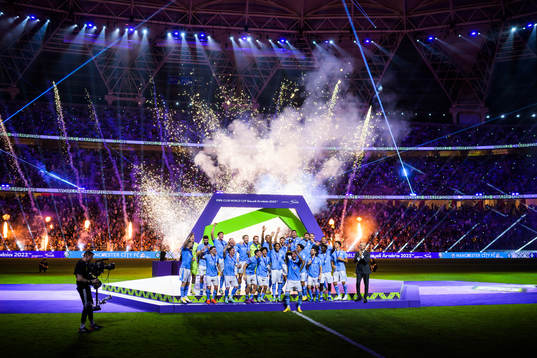 Kyle Walker of Manchester City hoists the winner’s trophy
