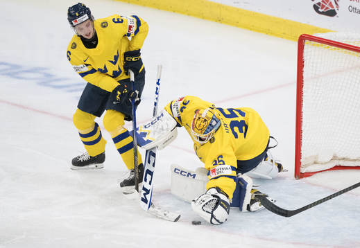 Anton Johansson and goaltender Hugo Hävelid of Sweden