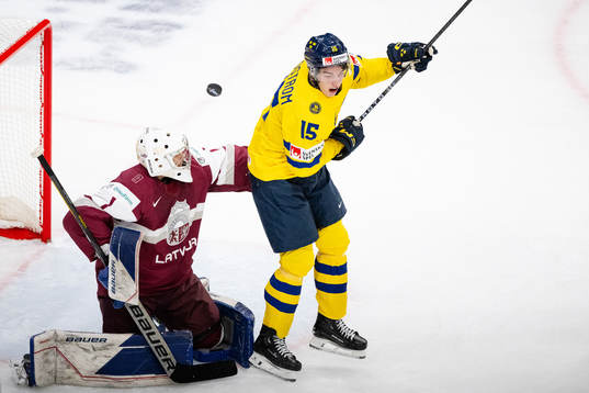 Goaltender Deivs Rolovs of Latvia and David Edstrom of