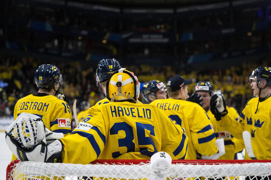 Players of Sweden celebrate with goaltender Hugo Hävelid