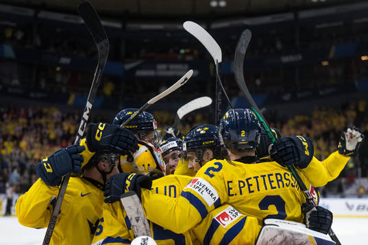 Players of Sweden celebrate with goaltender Hugo Hävelid