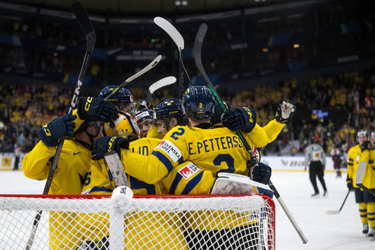 Players of Sweden celebrate with goaltender Hugo Hävelid