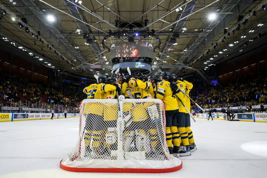 Players of Sweden celebrate with goaltender Hugo Hävelid