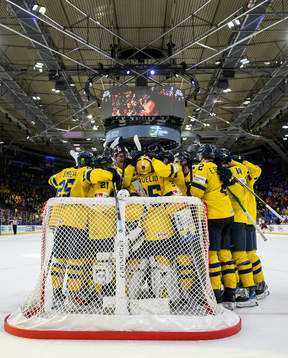Players of Sweden celebrate with goaltender Hugo Hävelid