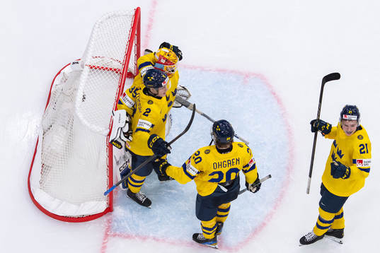 Goaltender Hugo Hävelid of Sweden celebrate with teammates