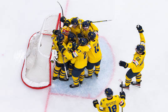 Goaltender Hugo Hävelid of Sweden celebrate with teammates