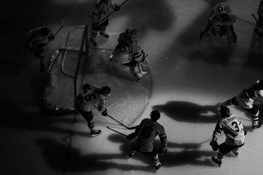 Players of Sweden gather around goaltender Hugo Hävelid