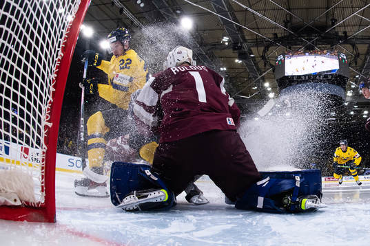 Anton Wahlberg of Sweden and goaltender Deivs Rolovs of