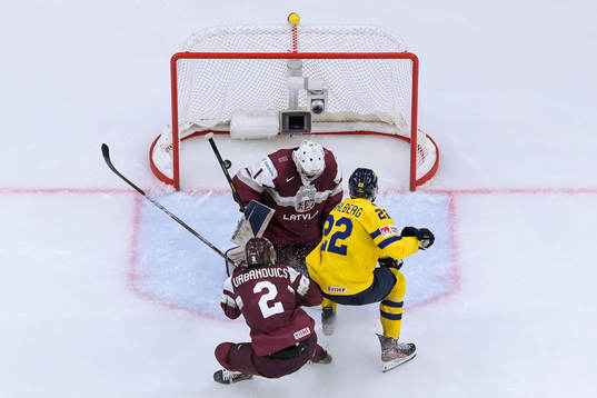 Anton Wahlberg of Sweden against goaltender Deivs Rolovs of