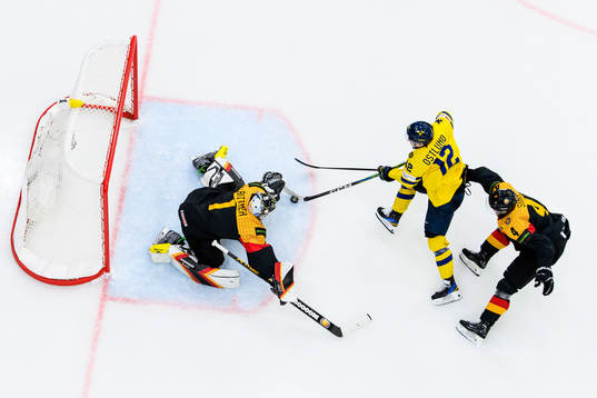 goaltender Matthias Bittner and Phillip Sinn of Germany