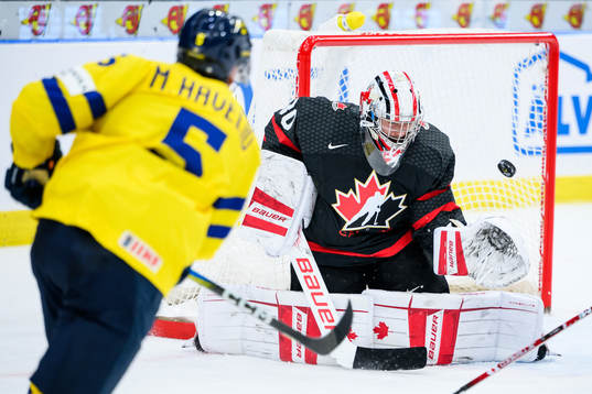 Mattias Hävelid of Sweden and goaltender Mathis Rousseau