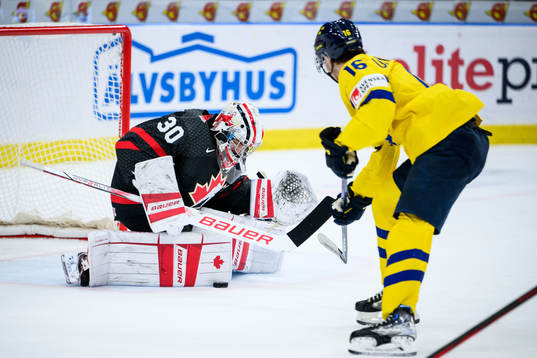 Goaltender Mathis Rousseau of Canada and Felix Unger Sörum
