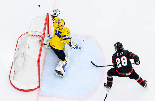 goaltender Hugo Hävelid of Sweden and Conor Geekie of