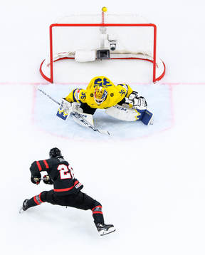 goaltender Hugo Hävelid of Sweden and Matthew Savoie of