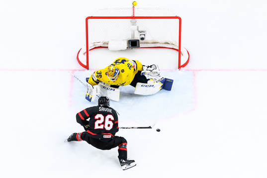 goaltender Hugo Hävelid of Sweden and Matthew Savoie of