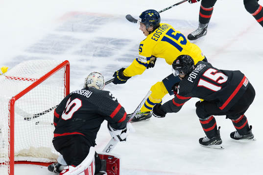 Goalkeeper Mathis Rousseau and Matthew Poitras of Canada