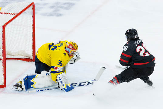 Goaltender Hugo Hävelid of Sweden and Matthew Savoie of