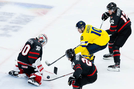 Goaltender Mathis Rousseau of Canada and Fabian Wagner of